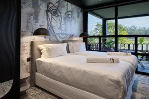 a bedroom with two beds and a large window at Cargo88 Hotel in Lusaka