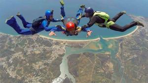 a group of three people flying over a city at Casa Paulinho in Portimão