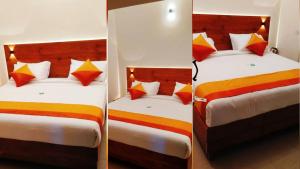 two twin beds in a room with a mirror at CJ Cottage Munnar - Near Attukal Waterfalls, Athukad Tea Estate (CJ Hotels & Resorts) in Devikolam