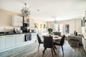 a kitchen and dining room with a table and chairs at Spacious & Bright 2 Bed Apartment in Manchester in Manchester