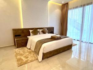 - une chambre avec un grand lit et une grande fenêtre dans l'établissement Palais Thami, à Marrakech