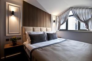 a bedroom with a large bed with a window at VALİDE RESİDENCE in Istanbul