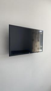 a flat screen tv on a white wall at nana house in London