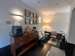 a living room with a tv on a dresser and a couch at Dizengoff 208 Hotel Tel Aviv in Tel Aviv