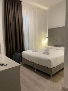 Postel nebo postele na pokoji v ubytování Hotel l'Etrusco - San Vincenzo
