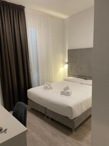 Postel nebo postele na pokoji v ubytování Hotel l'Etrusco - San Vincenzo
