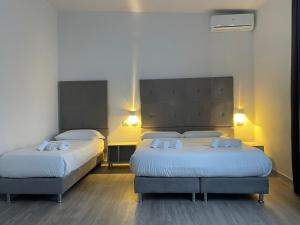 Postel nebo postele na pokoji v ubytování Hotel l'Etrusco - San Vincenzo
