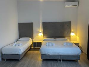 Postel nebo postele na pokoji v ubytování Hotel l'Etrusco - San Vincenzo
