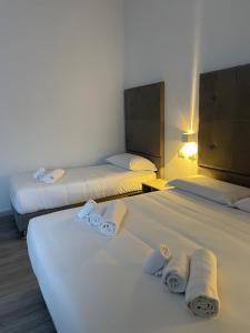 Postel nebo postele na pokoji v ubytování Hotel l'Etrusco - San Vincenzo