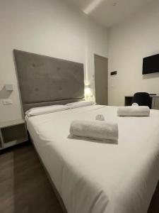 Postel nebo postele na pokoji v ubytování Hotel l'Etrusco - San Vincenzo