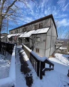 a large barn with snow on it in the yard at Stylish Townhouse Steps to Ski Mtn & Waterpark in Tannersville