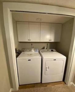 a kitchen with a stove and a washer and dryer at Stylish Townhouse Steps to Ski Mtn & Waterpark in Tannersville