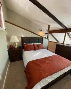 a bedroom with a large bed with red pillows at Stylish Townhouse Steps to Ski Mtn & Waterpark in Tannersville