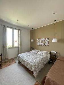 a bedroom with a bed and a window at A un Passo dal Tramonto in Marsala