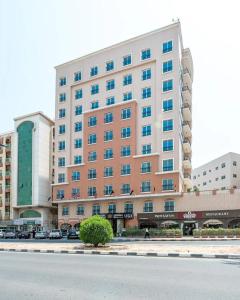 a large building on the side of a street at Zenith Smart Vacation Homes, Sharjah in Sharjah