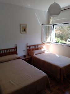 Postel nebo postele na pokoji v ubytování HOSTAL RESIDENCIA PRESIDENTE