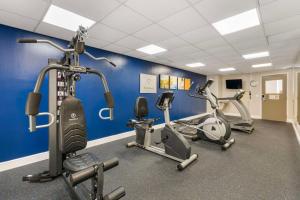 a gym with three exercise bikes in a room at Comfort Suites West Jacksonville in Jacksonville