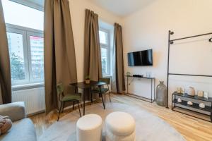 een woonkamer met een bank en een tafel en stoelen bij Delia Apartment I levestate in Wenen