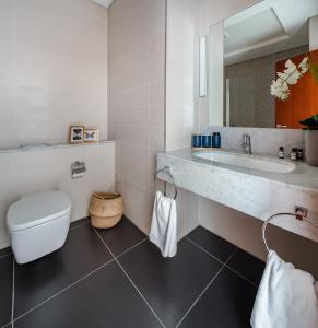 a bathroom with a toilet and a sink at Frank Porter - Central Park Towers in Dubai