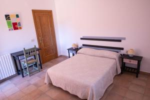 een slaapkamer met een bed, een tafel en een stoel bij Casa El Soldau in Naval