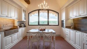 a kitchen with a table and chairs and a window at Villa La Selva Wine Resort in Bucine