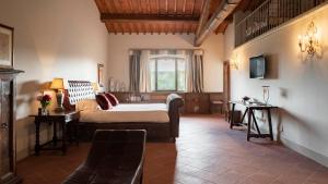 a bedroom with a bed and a window at Villa La Selva Wine Resort in Bucine