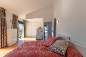 a bedroom with a red bed with two pillows at Llucmajor -1630 Mallorca in Llucmajor