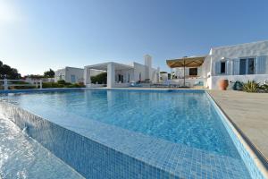 a swimming pool in front of a villa at Bright Blue Villas-Villa Malinda in Aliki