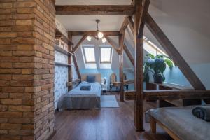 a loft bedroom with a bed and a brick wall at Giovanni's Airport House in Budapest