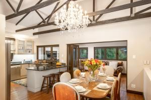 a dining room and kitchen with a chandelier at Guesthouse Fort Knox in Kokstad
