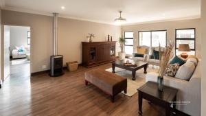 a living room with a couch and a table at Guesthouse Fort Knox in Kokstad