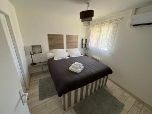 una camera da letto con un letto e due asciugamani di La Tuilerie St Michel a Saint-Michel-de-Fronsac