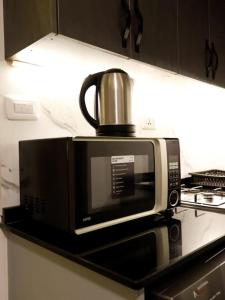 a microwave sitting on a shelf in a kitchen at privet (35)near downtown JRE in Amman