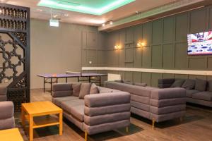 a waiting room with couches and a tv at The Dawson Hostel in Dublin