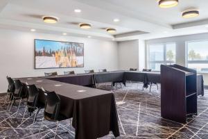 a conference room with black tables and chairs at Microtel Inn & Suites by Wyndham Kanata Ottawa West in Kanata