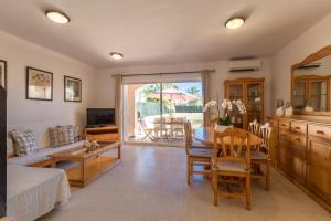 a living room with a table and a couch at Puerto de Alcudia -2765 Mallorca in Port d'Alcudia