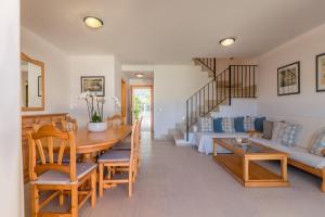 a living room with a table and a couch at Puerto de Alcudia -2765 Mallorca in Port d'Alcudia