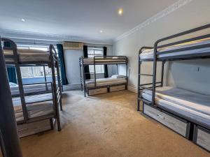 a room with three bunk beds in it at The Dawson Hostel in Dublin