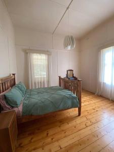 a bedroom with a bed and a wooden floor at McIntyre homestead in Penshurst