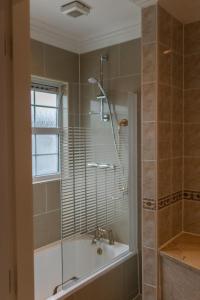 a bathroom with a shower and a bath tub at The Dawson Hostel in Dublin