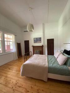 a bedroom with a bed and a wooden floor at McIntyre homestead in Penshurst