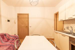 a kitchen with a table and chairs and a sink at Guest House da Generoso in Pesaro