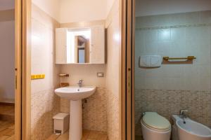 a small bathroom with a sink and a toilet at Guest House da Generoso in Pesaro
