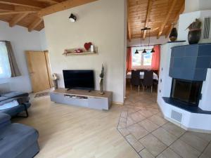 a living room with a couch and a television at Ferienwohnung Mark-Oehmen in Imst