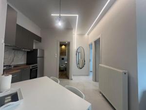 a kitchen with a table and chairs and a mirror at Ladadika Fine Living in Thessaloniki
