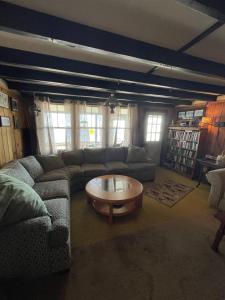 a living room with a couch and a coffee table at 1901 HOUSE LIMIT 10 cottage in North Sebago +15 photos
