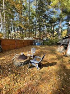 a yard with a chair and a fire pit at 1901 HOUSE LIMIT 10 cottage in North Sebago