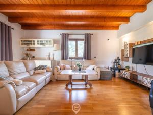 a living room with a couch and a table at Estay - Garden Paradise Escape - BBQ AirCon in Baratili San Pietro +22 photos