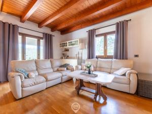 a living room with a couch and a table at Estay - Garden Paradise Escape - BBQ AirCon in Baratili San Pietro