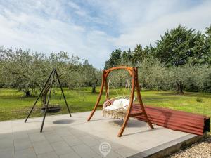 a swing set in a park with a field at Estay - Garden Paradise Escape - BBQ AirCon in Baratili San Pietro
